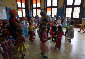 Dzieci bawią się na sali gimnastycznej do muzyki